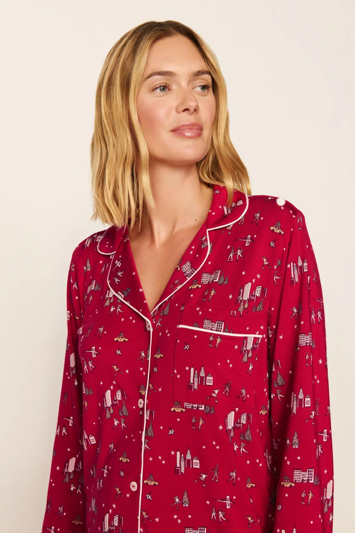 Model is wearing Gisele Printed TENCEL™ Modal Long PJ Set in Winter Skating Holly Red/Ivory