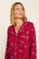 Model is wearing Gisele Printed TENCEL™ Modal Long PJ Set in Winter Skating Holly Red/Ivory