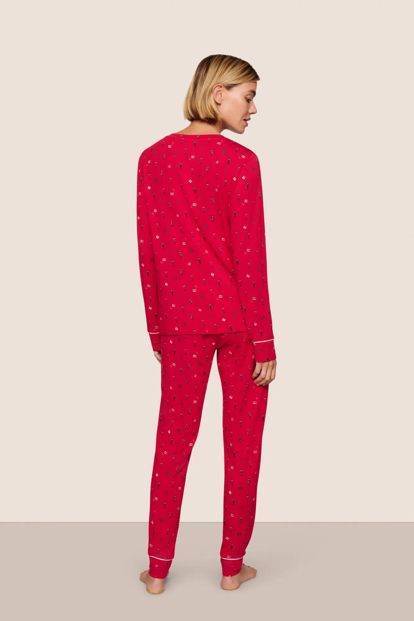 Model is wearing Gisele Printed TENCEL™ Modal Crewneck PJ Set  in Nutcracker Holly Red/Ivory