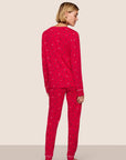 Model is wearing Gisele Printed TENCEL™ Modal Crewneck PJ Set  in Nutcracker Holly Red/Ivory