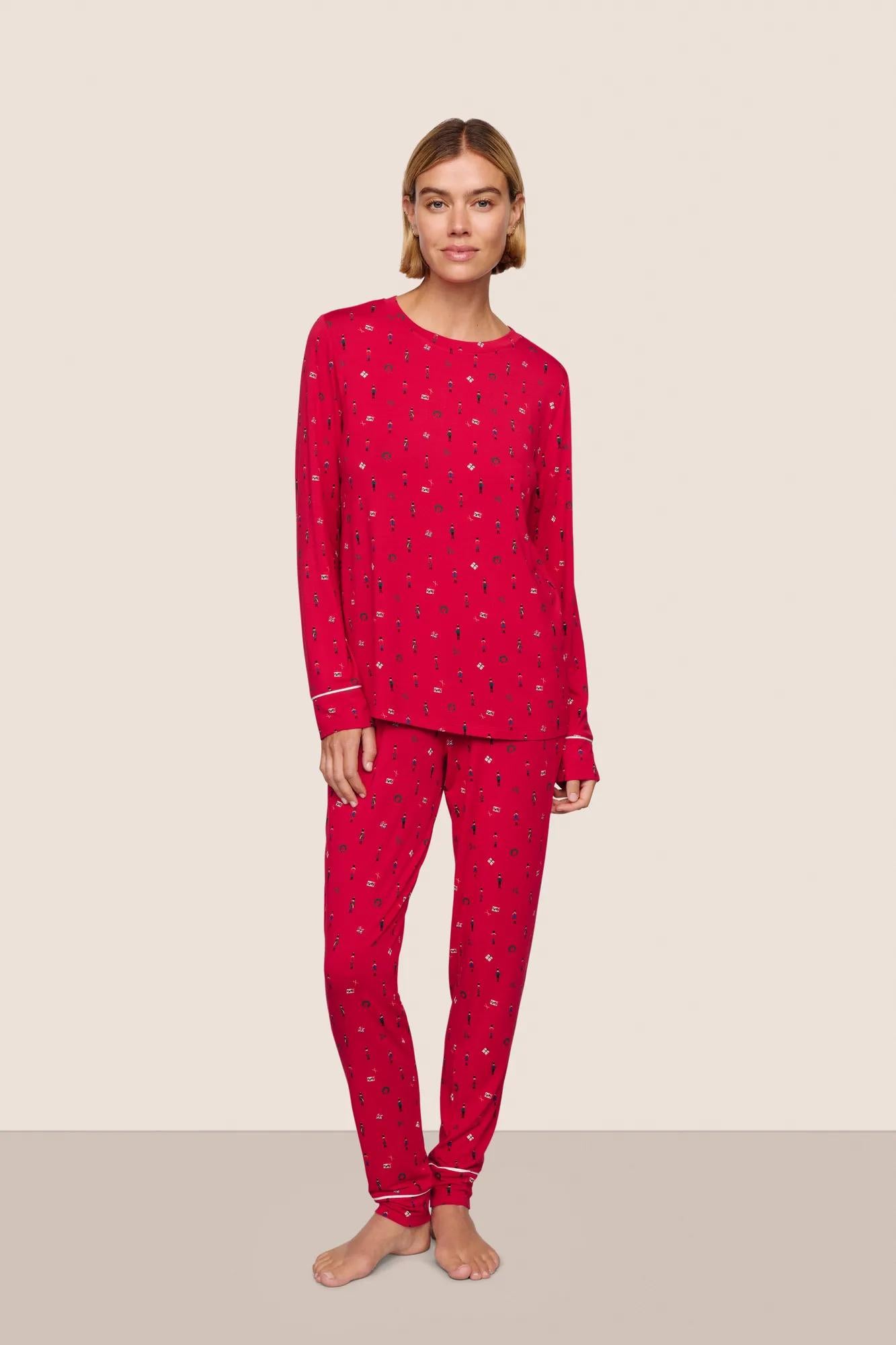 Model is wearing Gisele Printed TENCEL™ Modal Crewneck PJ Set  in Nutcracker Holly Red/Ivory
