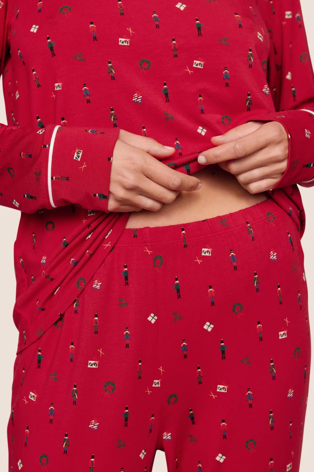 Model is wearing Gisele Printed TENCEL™ Modal Crewneck PJ Set  in Nutcracker Holly Red/Ivory