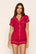 Model is wearing Gisele Printed TENCEL™ Modal Shortie Short PJ Set in Hollyberry Holly Red/Ivory