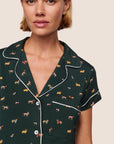 Model is wearing Gisele Printed TENCEL™ Modal Shortie Short PJ Set  in Holiday Dogs Pine/Ivory