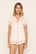 Model is wearing Gisele Printed TENCEL™ Modal Shortie Short PJ Set in Mini Bow Ivory/Holly Red
