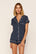 Model is wearing Gisele Printed TENCEL™ Modal Shortie Short PJ Set in Santa Paws Navy/Ivory