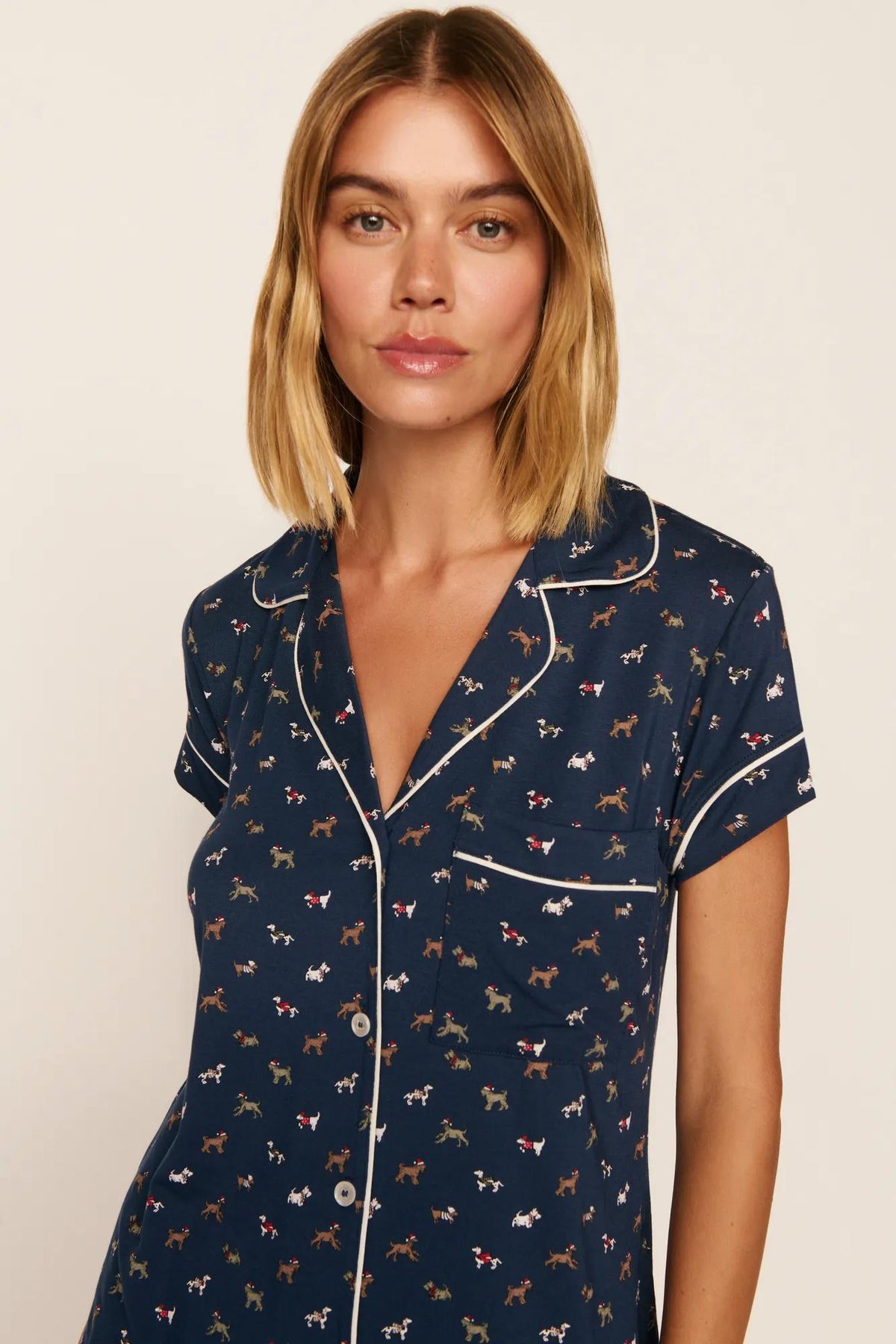 Model is wearing Gisele Printed TENCEL™ Modal Shortie Short PJ Set in Santa Paws Navy/Ivory