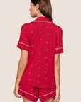 Model is wearing Gisele Printed TENCEL™ Modal Relaxed Short PJ Set  in Nutcracker Holly Red/Ivory