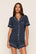 Model is wearing Gisele Printed TENCEL™ Modal Relaxed Short PJ Set in Santa Paws Navy/Ivory