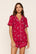 Model is wearing Gisele Printed TENCEL™ Modal Relaxed Short PJ Set in Winter Skating Holly Red/Ivory
