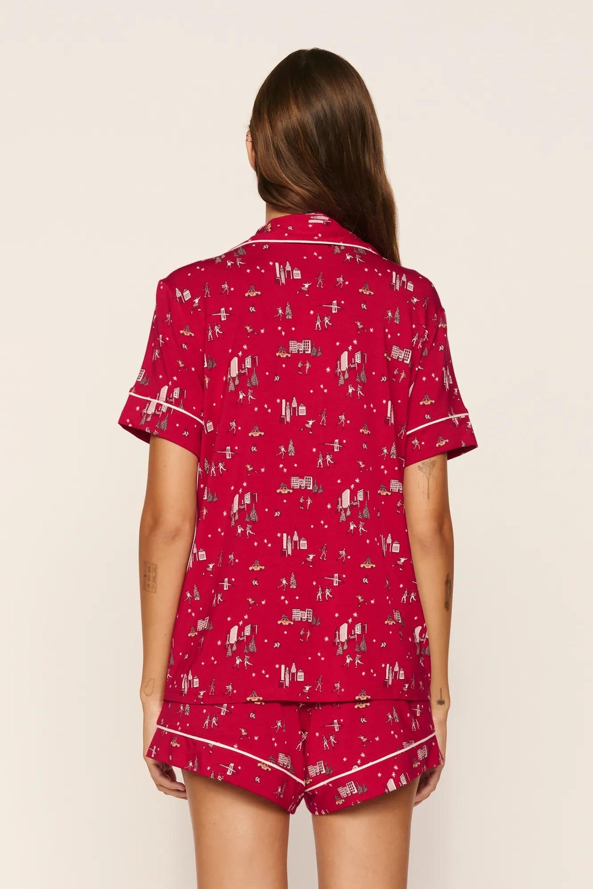 Model is wearing Gisele Printed TENCEL™ Modal Relaxed Short PJ Set in Winter Skating Holly Red/Ivory