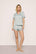 Model is wearing Inez Washable Silk Printed Short PJ Set in Waves Memorable Blue/Navy