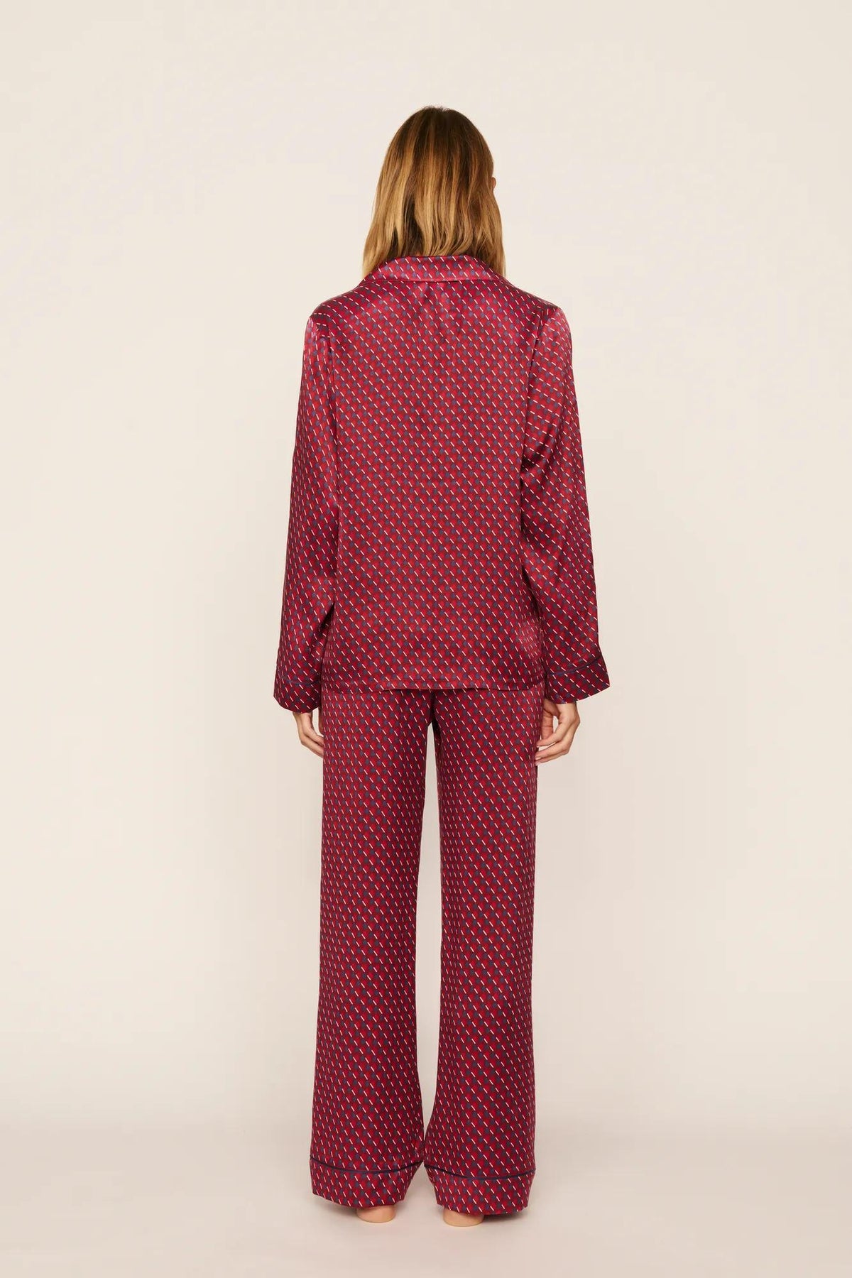 Model is wearing Inez Washable Silk Printed Long PJ Set in Harlequin Holly Red/Navy