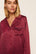 Model is wearing Inez Washable Silk Printed Long PJ Set in Harlequin Holly Red/Navy