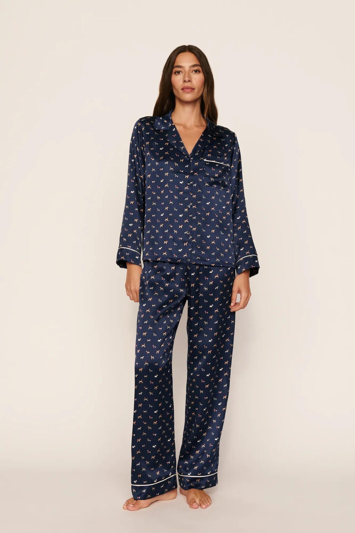 Model is wearing Inez Washable Silk Printed Long PJ Set in Santa Paws Navy/Ivory