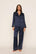 Model is wearing Inez Washable Silk Printed Long PJ Set in Santa Paws Navy/Ivory