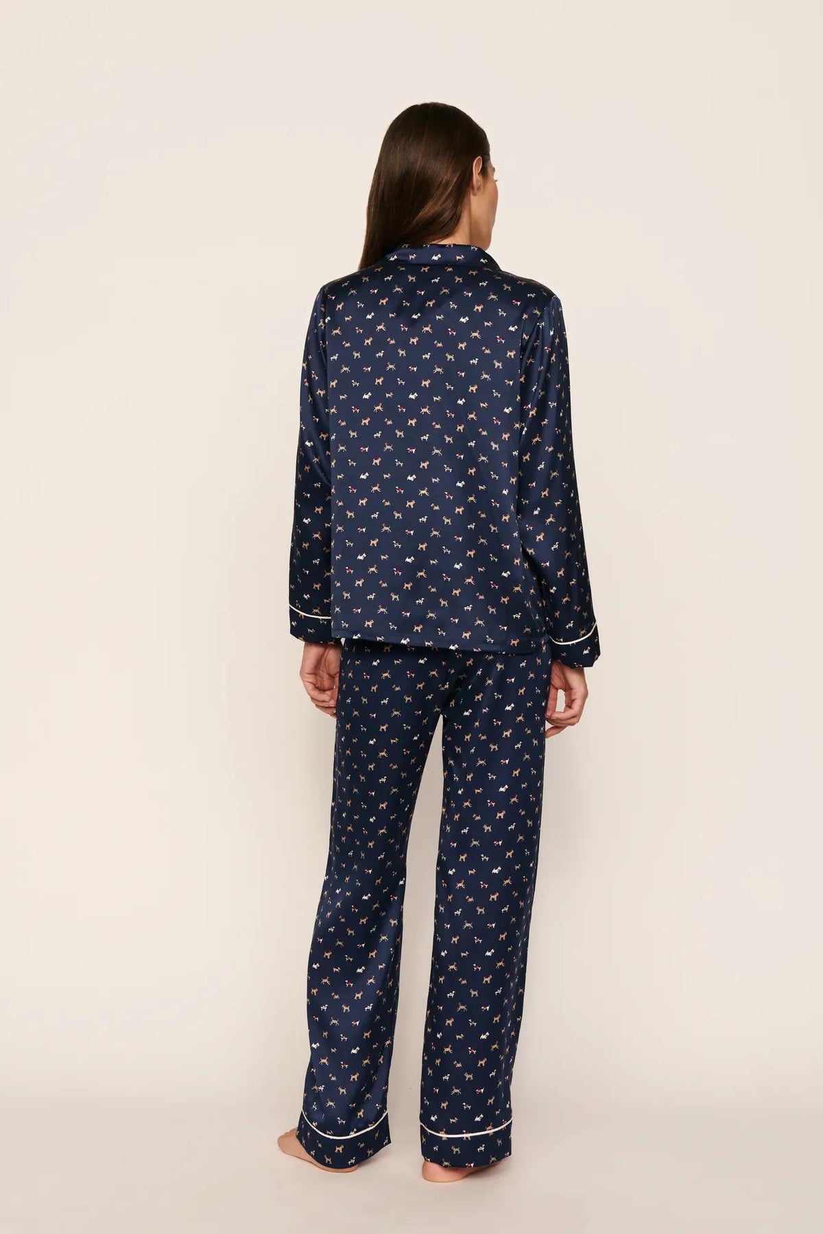 Model is wearing Inez Washable Silk Printed Long PJ Set in Santa Paws Navy/Ivory