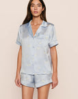 Model is wearing Inez Washable Silk Printed Short PJ Set in Large Swans Powder Blue/Ivory