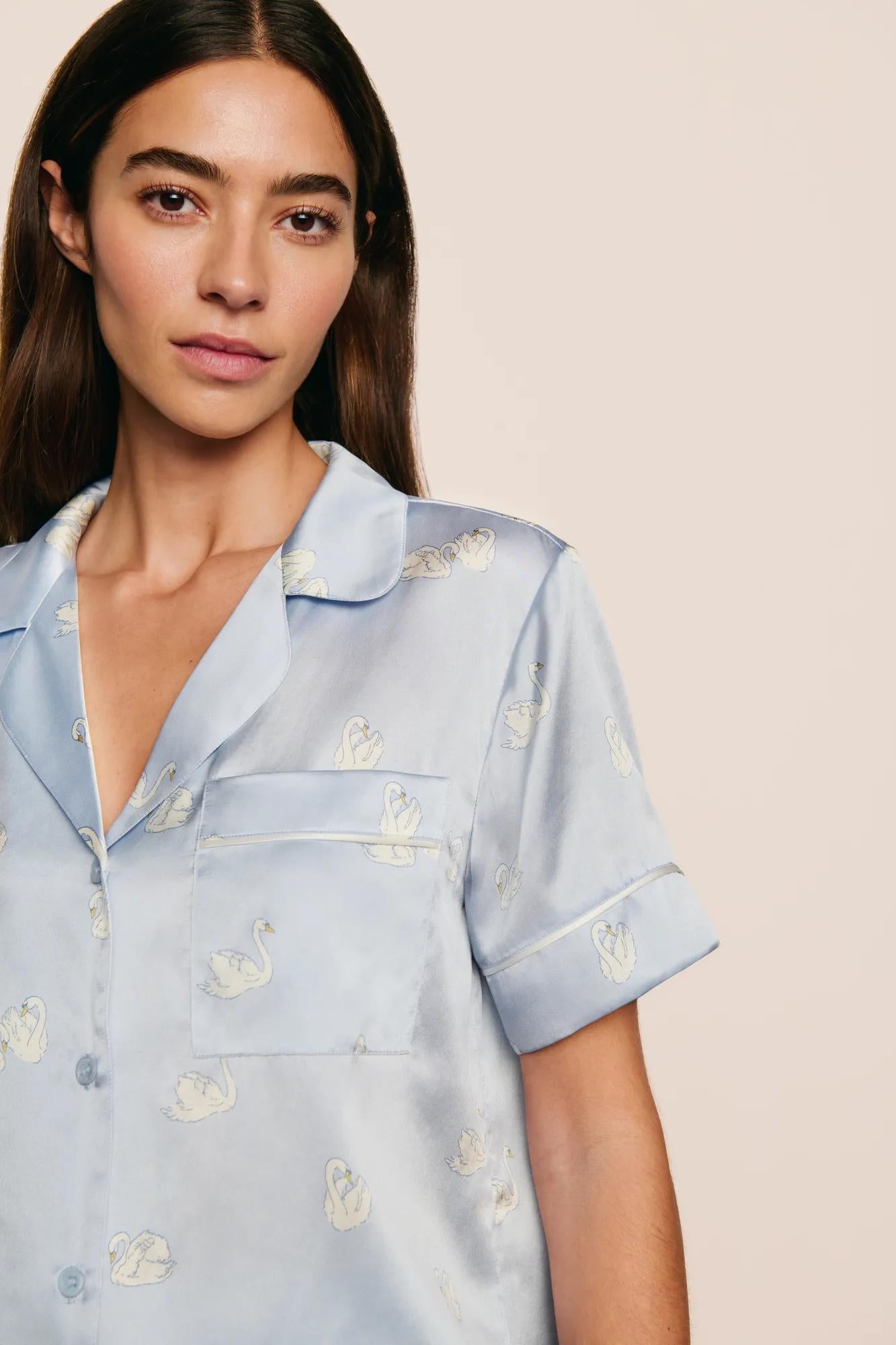 Model is wearing Inez Washable Silk Printed Short PJ Set in Large Swans Powder Blue/Ivory