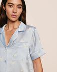 Model is wearing Inez Washable Silk Printed Short PJ Set in Large Swans Powder Blue/Ivory