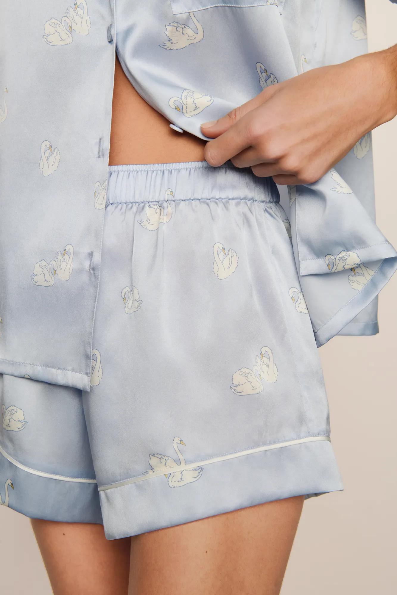 Model is wearing Inez Washable Silk Printed Short PJ Set in Large Swans Powder Blue/Ivory