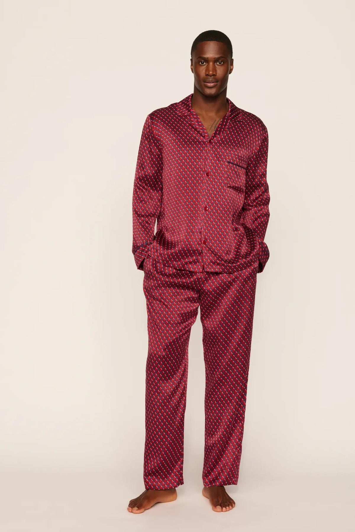 Model is wearing Charles Washable Silk Printed Long PJ Set in Harlequin Holly Red/Navy