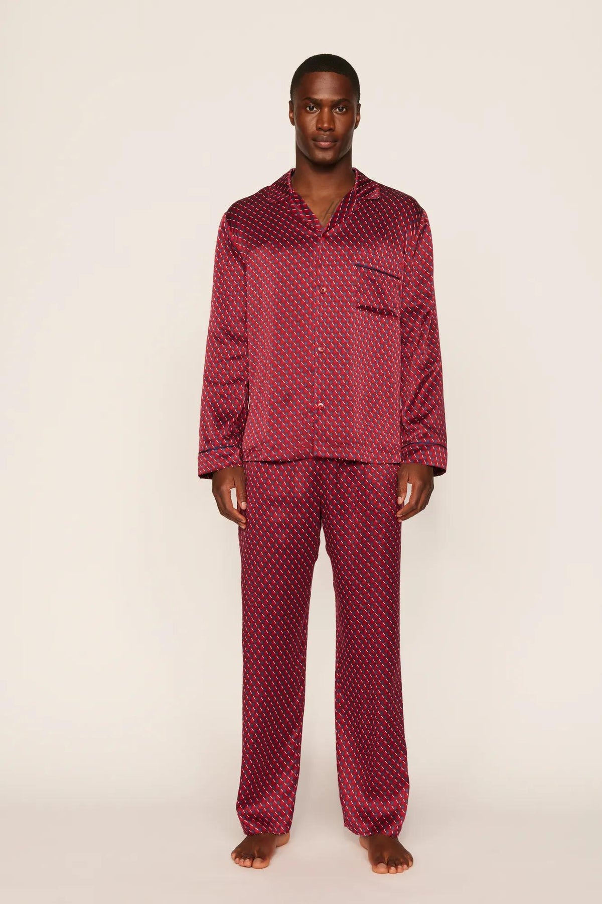 Model is wearing Charles Washable Silk Printed Long PJ Set in Harlequin Holly Red/Navy