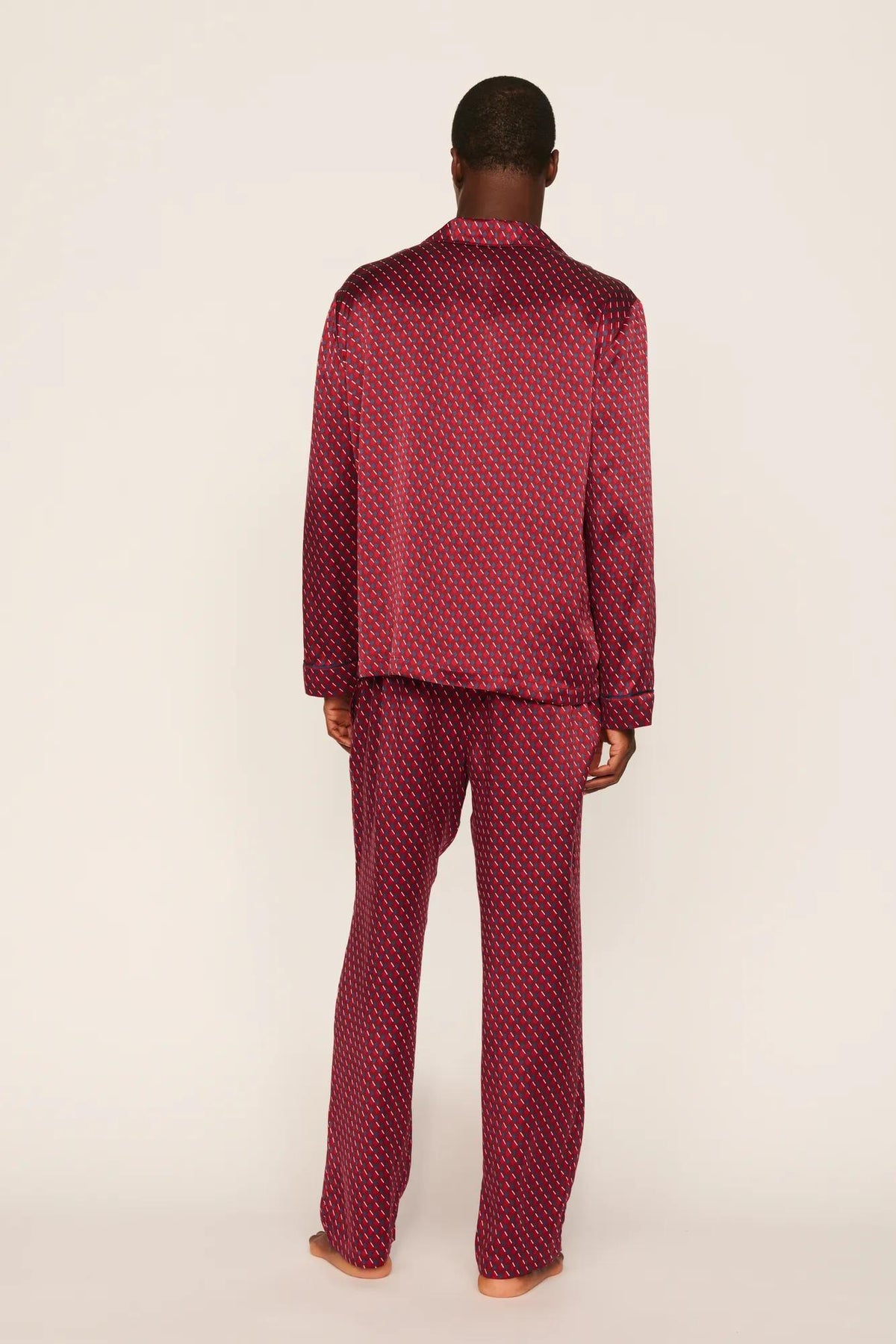 Model is wearing Charles Washable Silk Printed Long PJ Set in Harlequin Holly Red/Navy