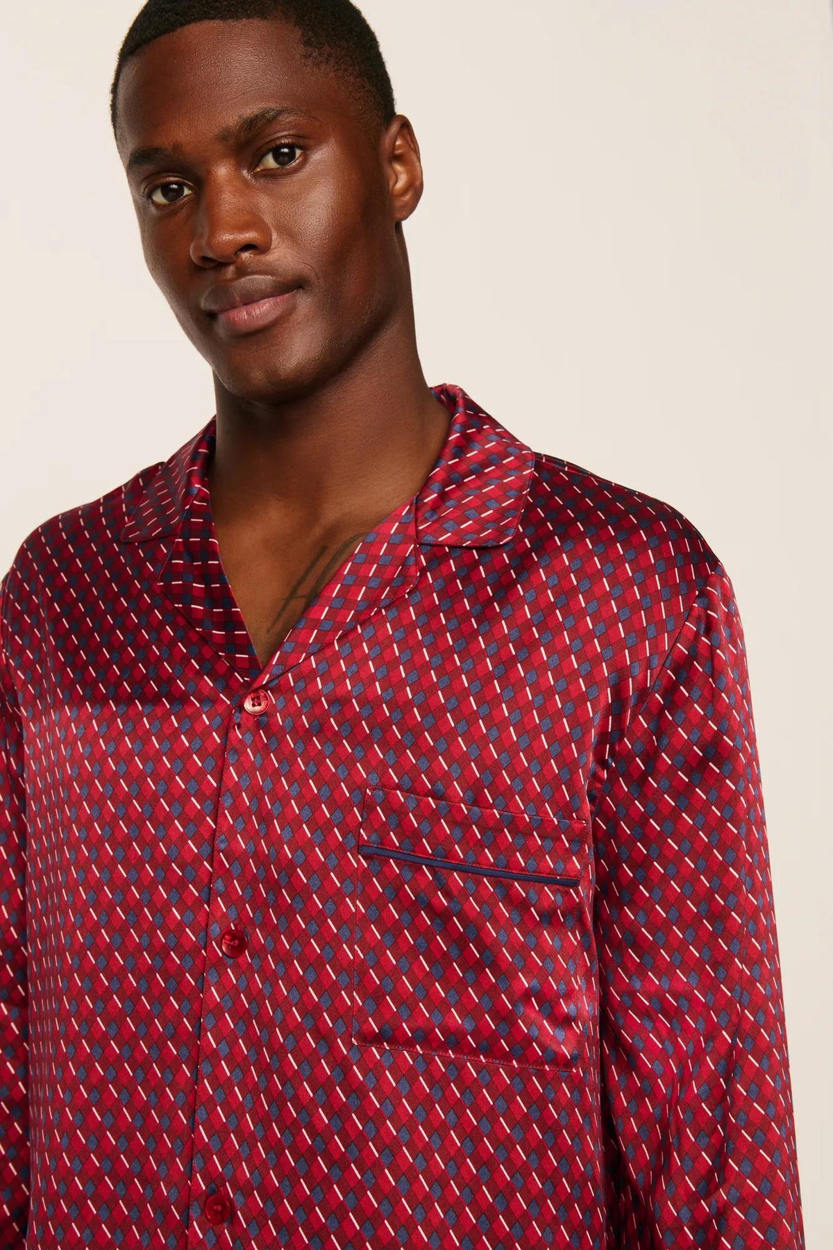 Model is wearing Charles Washable Silk Printed Long PJ Set in Harlequin Holly Red/Navy