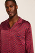 Model is wearing Charles Washable Silk Printed Long PJ Set in Harlequin Holly Red/Navy