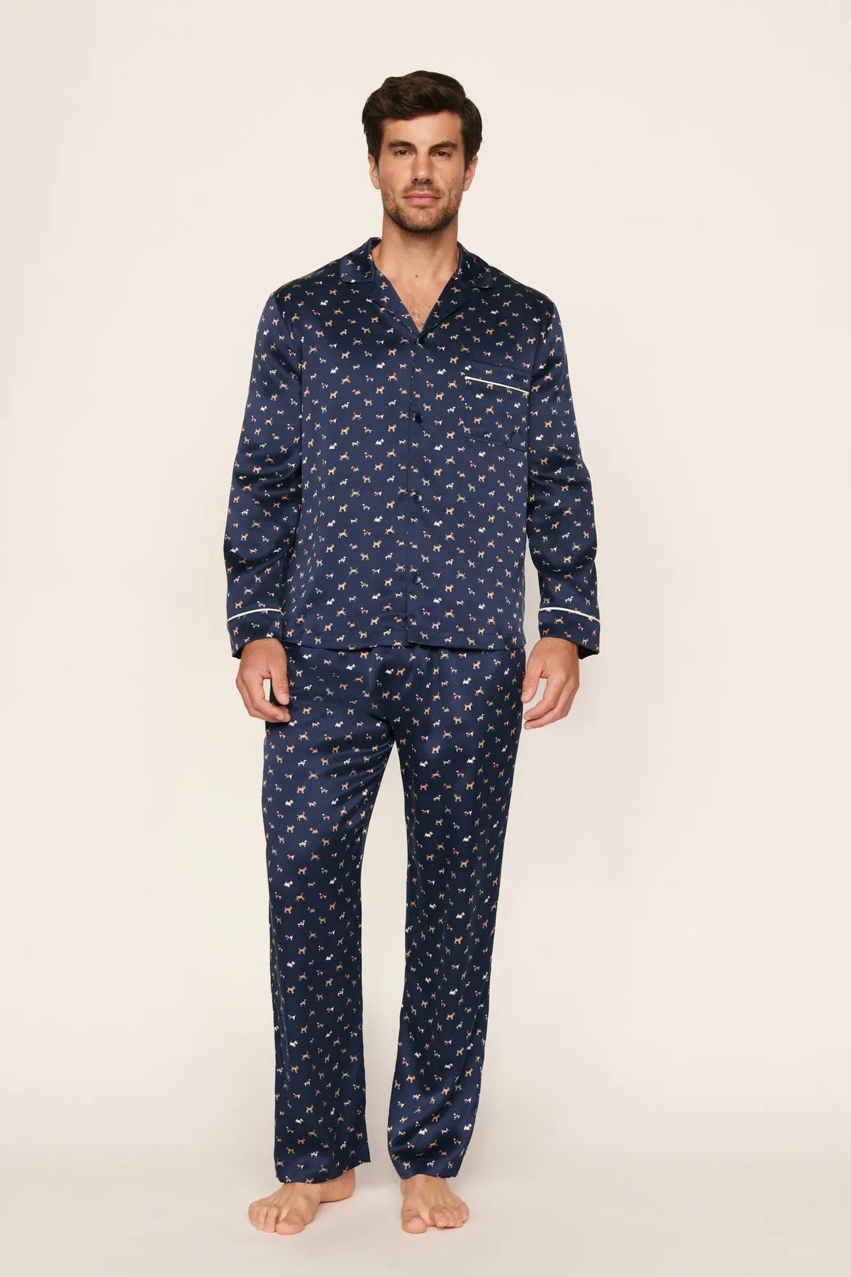 Model is wearing Charles Washable Silk Printed Long PJ Set in Santa Paws Navy/Ivory