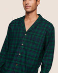 Model is wearing Men's Flannel Long PJ Set  in Blk Watch Tartan Rainforest/Na