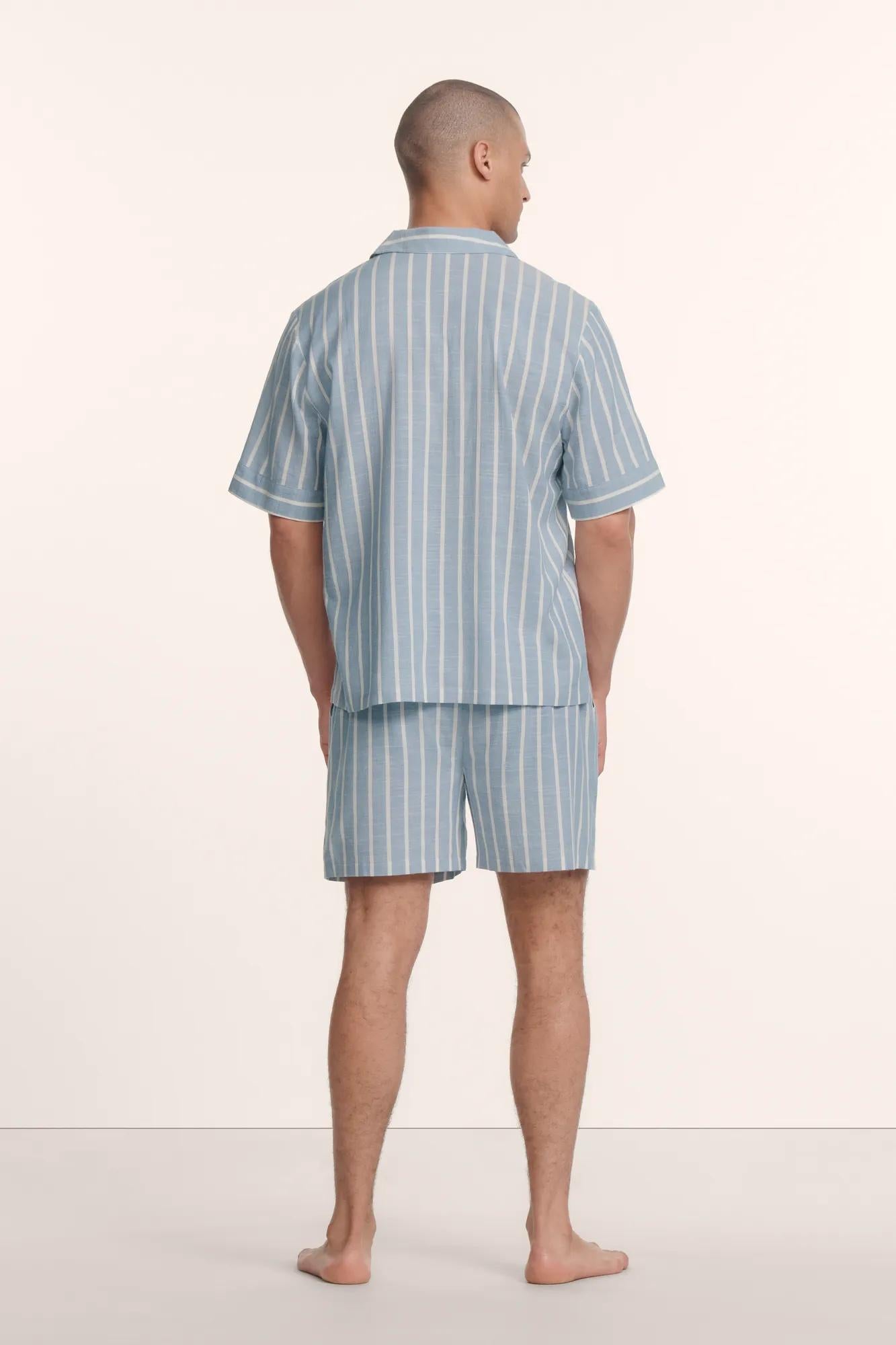 Model is wearing Men's Nautico Short PJ Set in Classic Stripe Slate Blue/Ivor