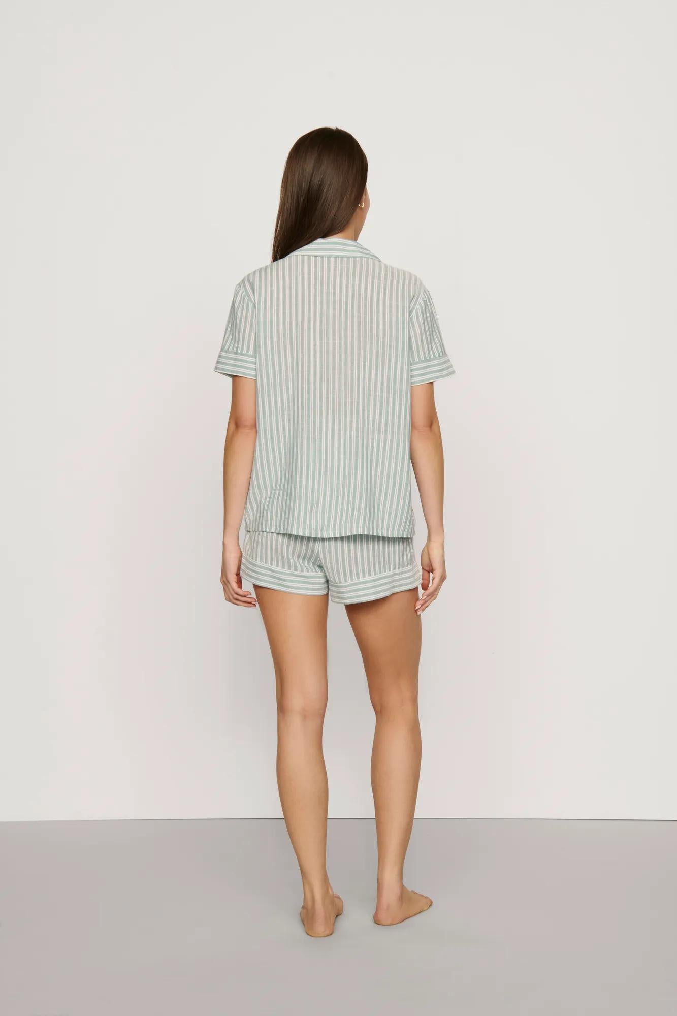 Model is wearing Nautico Shortie Short PJ Set in Regatta Stripe Seagrass/White