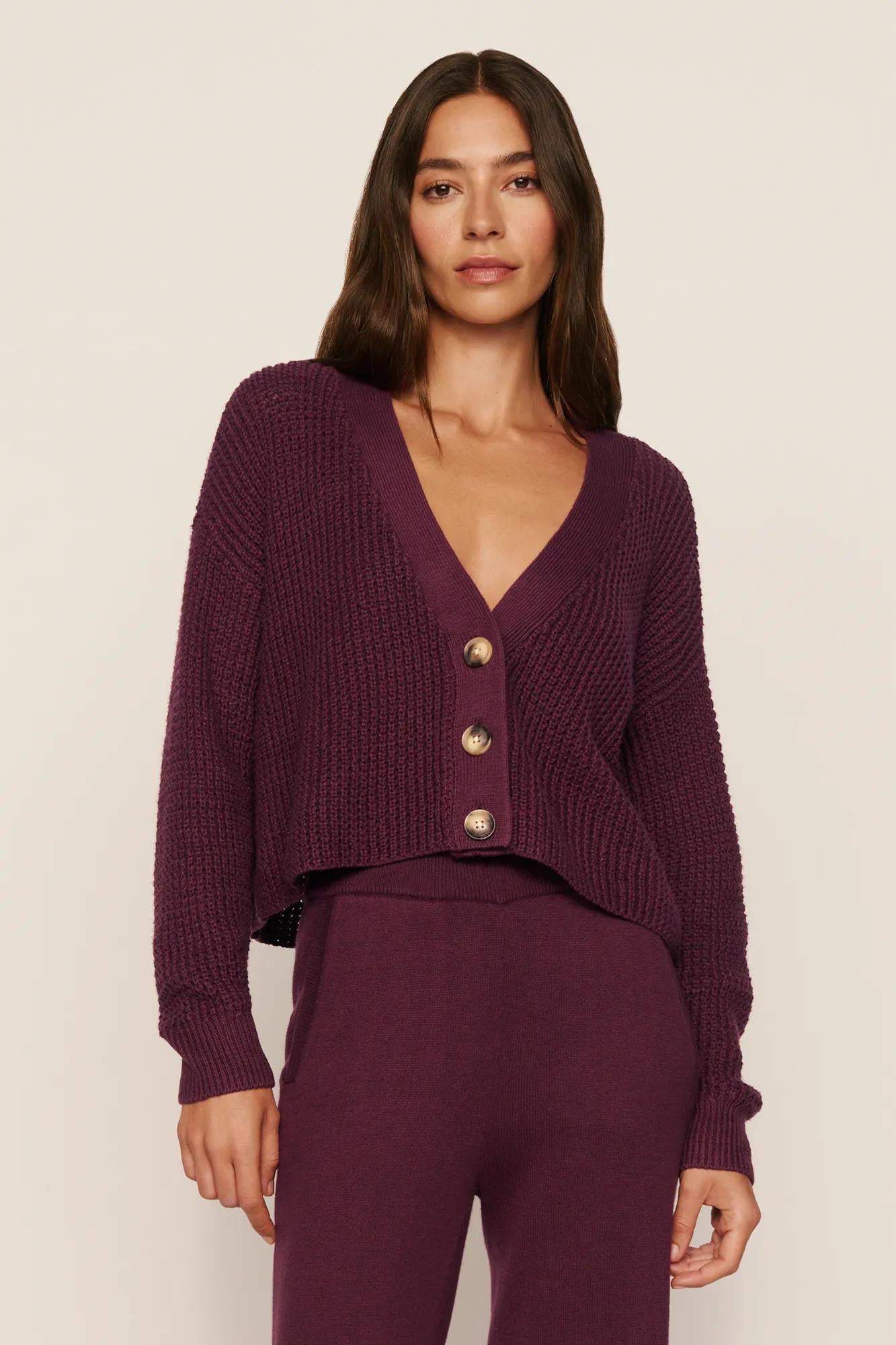 Model is wearing Recycled Sweater Cropped Cardigan in Wildberry