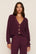 Model is wearing Recycled Sweater Cropped Cardigan in Wildberry
