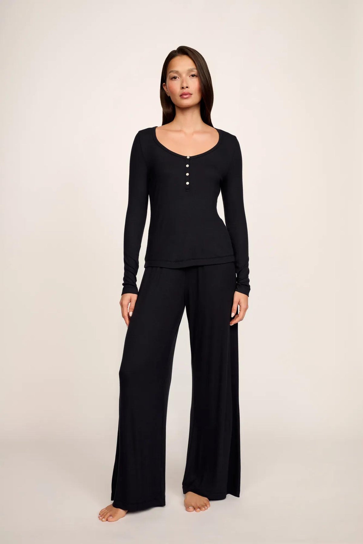 Model is wearing Dream Rib Long Sleeve Henley Tee in Black
