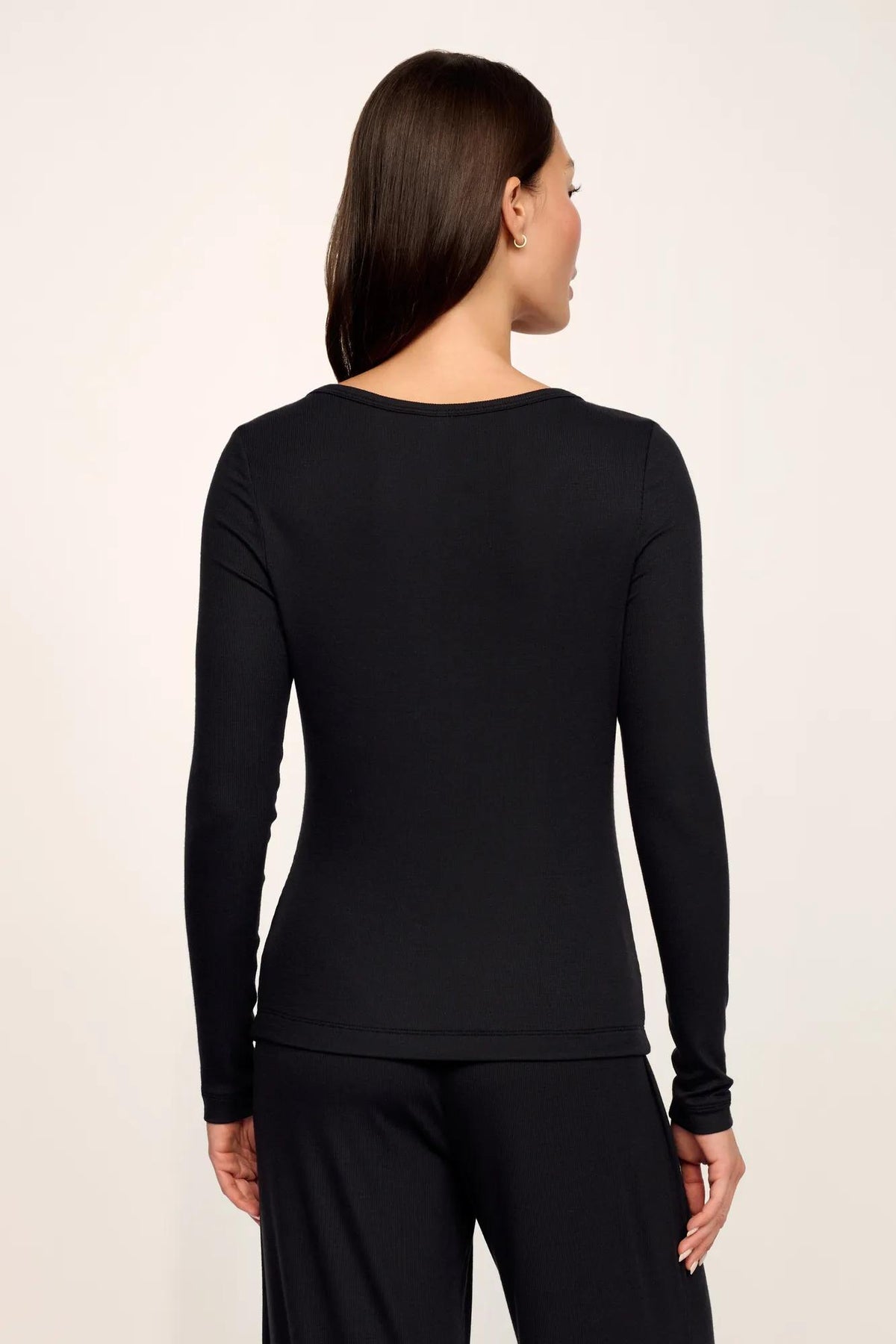 Model is wearing Dream Rib Long Sleeve Henley Tee in Black