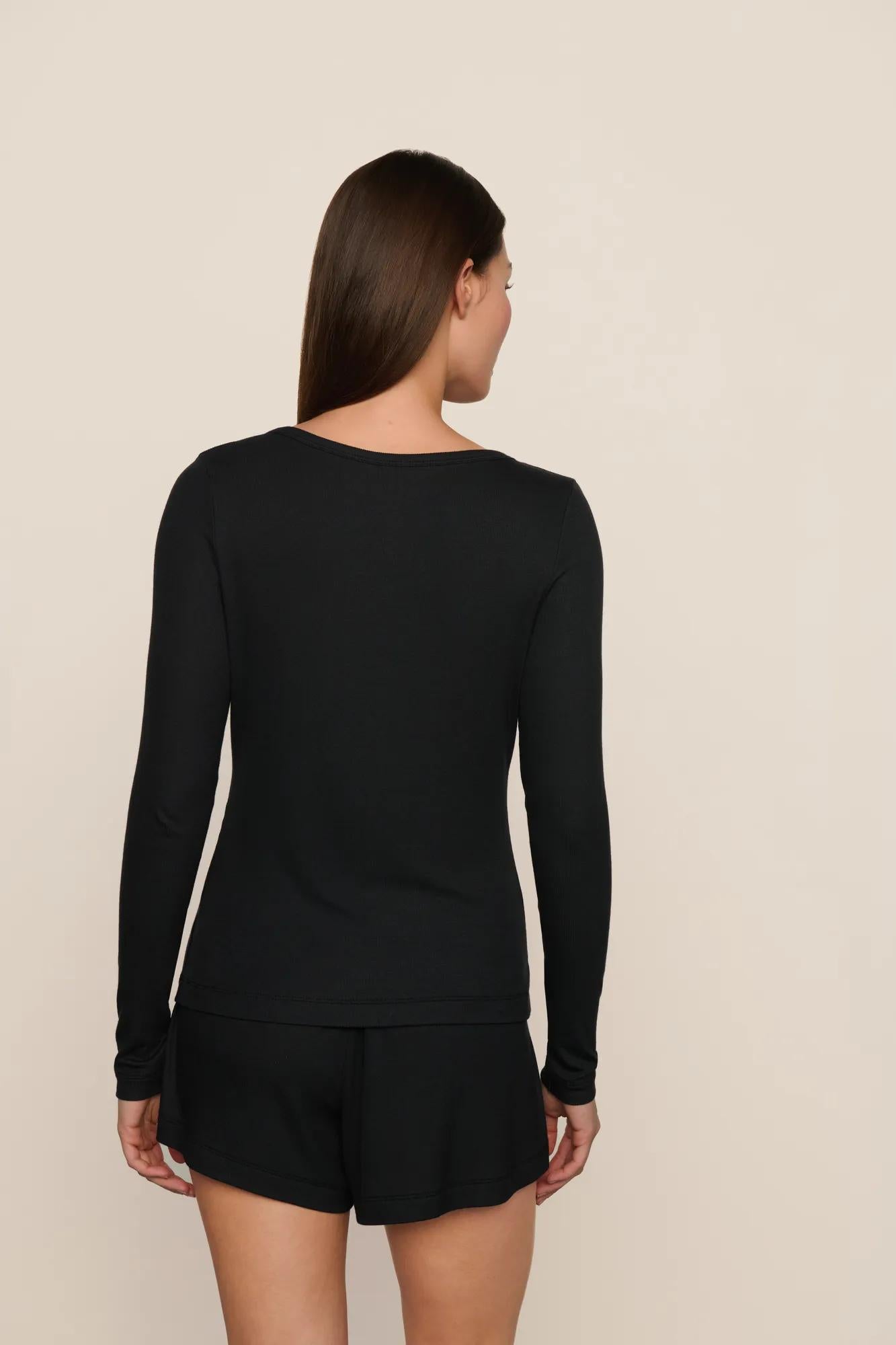 Model is wearing Dream Rib Long Sleeve Henley Tee in Black