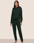 Model is wearing Recycled Boucle Hoodie  in Pine