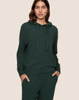 Model is wearing Recycled Boucle Hoodie  in Pine