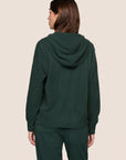 Model is wearing Recycled Boucle Hoodie  in Pine