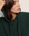 Model is wearing Recycled Boucle Hoodie  in Pine