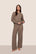 Model is wearing Recycled Boucle Pant  in Deep Taupe