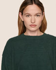 Model is wearing Recycled Boucle Crew Neck Pullover  in Pine