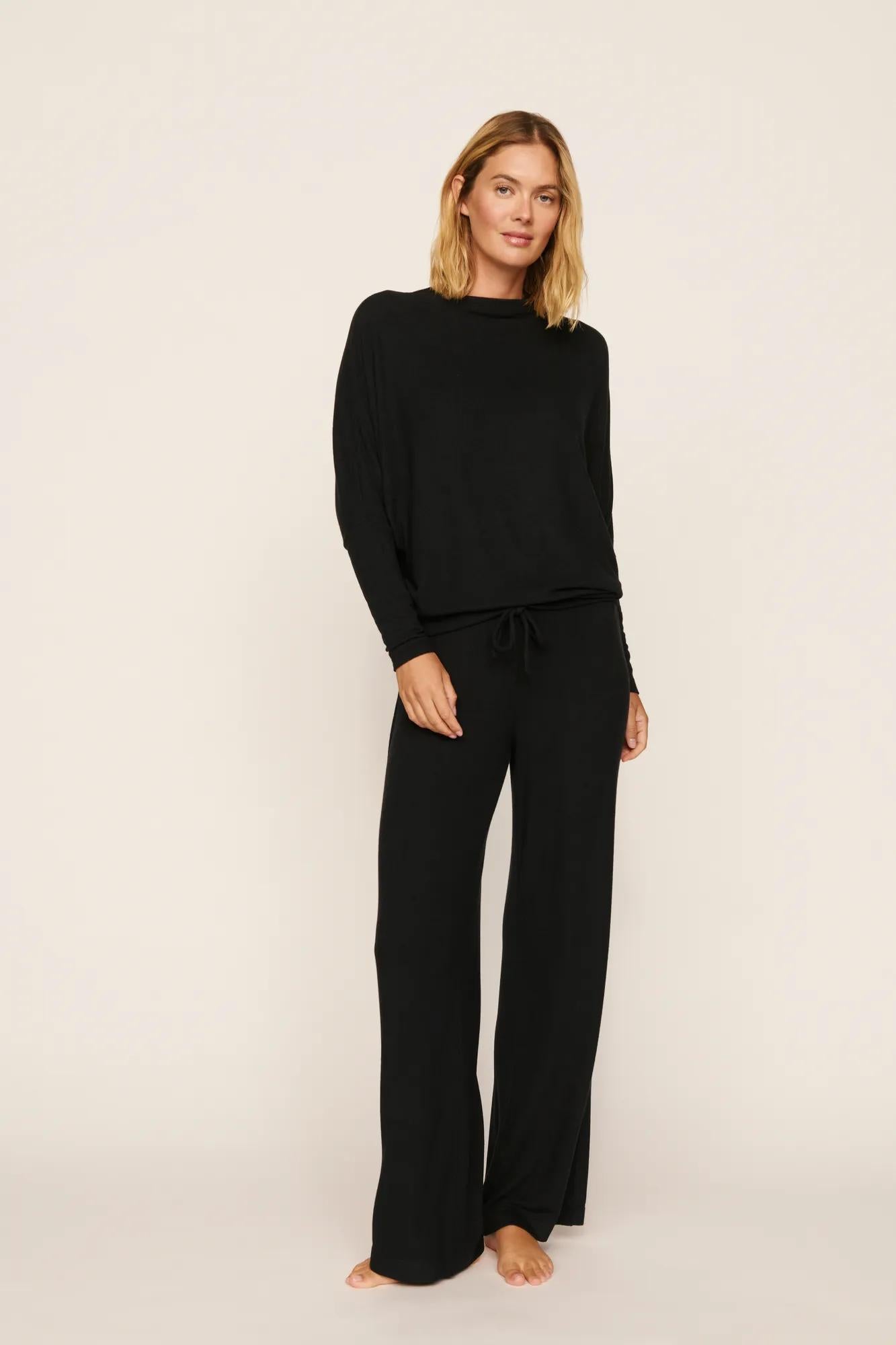 Model is wearing Cozy Time Mock Neck Pullover in Black