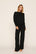 Model is wearing Cozy Time Mock Neck Pullover in Black