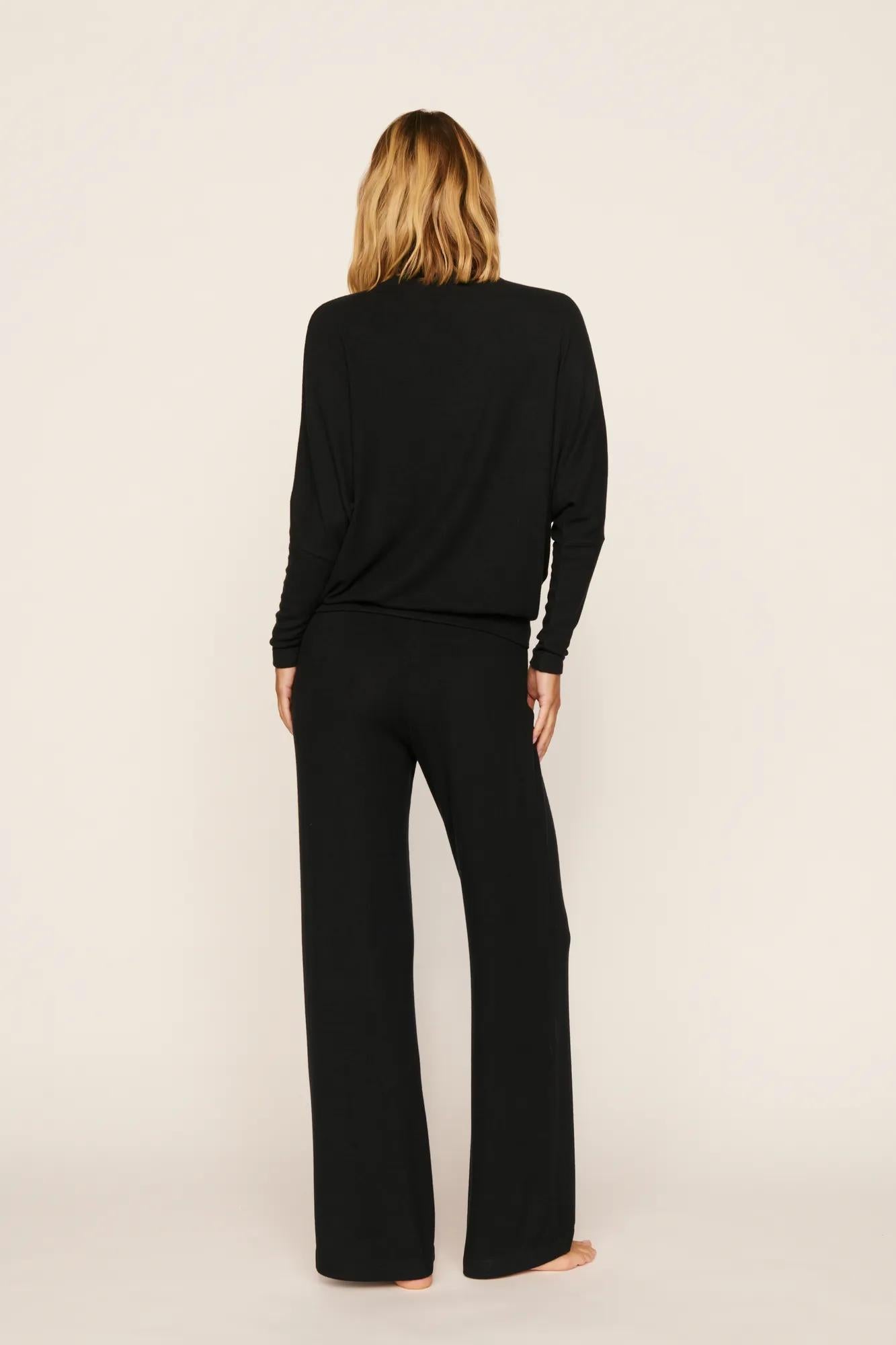 Model is wearing Cozy Time Mock Neck Pullover in Black