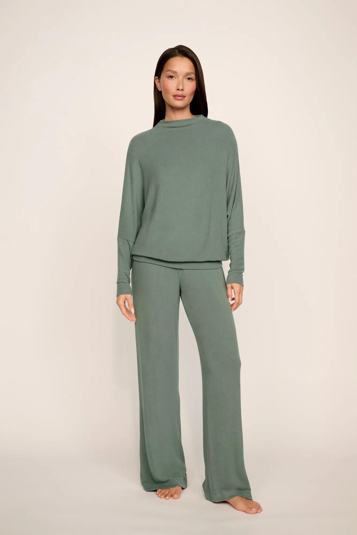 Model is wearing Cozy Time Mock Neck Pullover in Desert Sage
