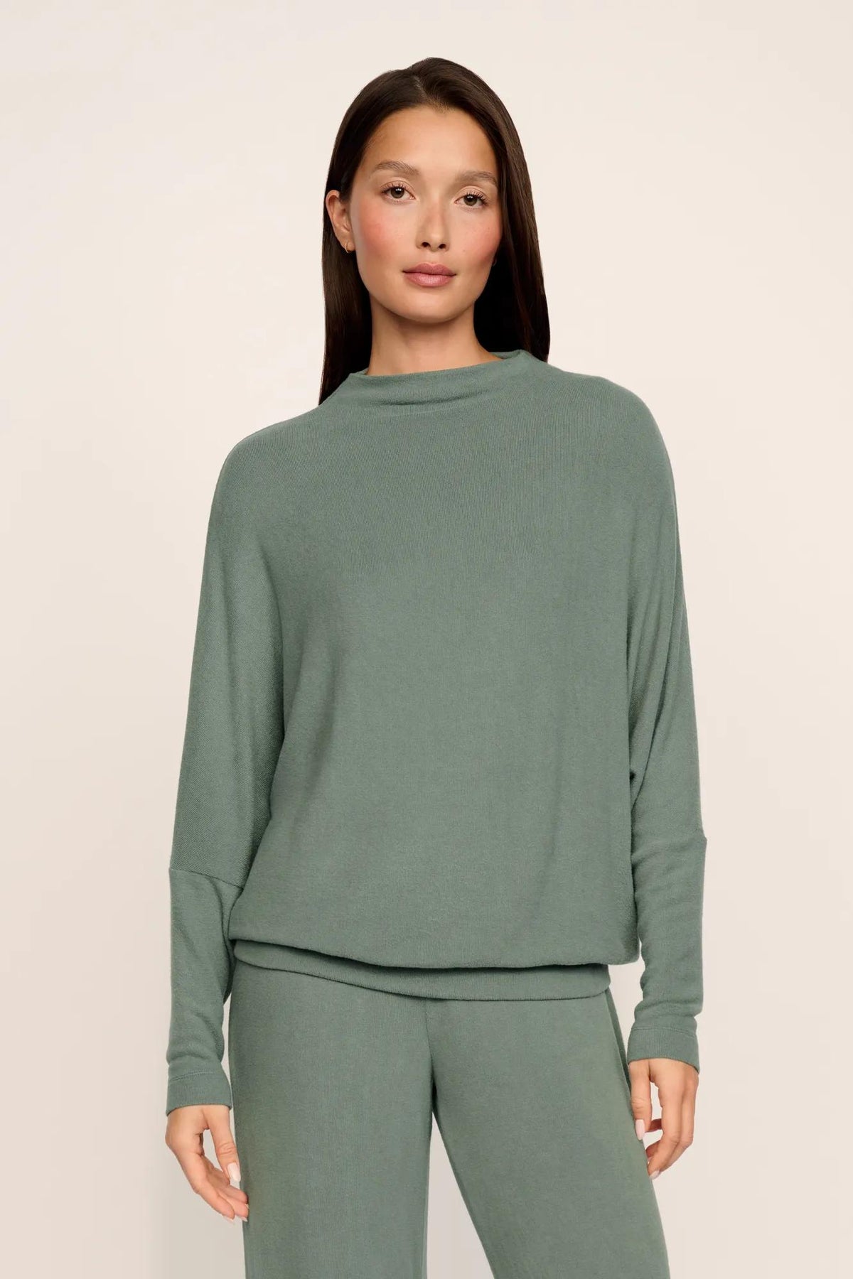 Model is wearing Cozy Time Mock Neck Pullover in Desert Sage